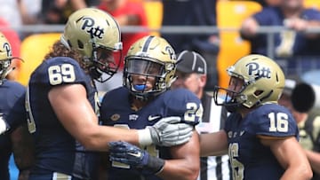 Sep 5, 2015; Pittsburgh, PA, USA; Pittsburgh Panthers running back James Conner (24) celebrates his second touchdown of the game with offensive lineman Adam Bisnowaty (69) and quarterback Chad Voytik (16) against the Youngstown State Penguins at Heinz Field. The Panthers won 45-37. Mandatory Credit: Charles LeClaire-USA TODAY Sports
