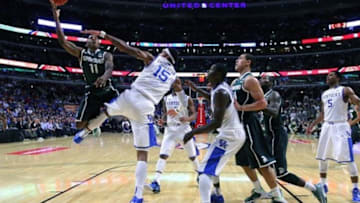 Nov 12, 2013; Chicago, IL, USA; Michigan State Spartans guard Keith Appling (11) shoots over Kentucky Wildcats forward Willie Cauley-Stein (15) during the first half at the United Center. Mandatory Credit: Dennis Wierzbicki-USA TODAY Sports
