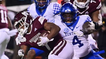 Oct 30, 2021; Starkville, Mississippi, USA; Mississippi State Bulldogs running back Jo'quavious Marks (7) runs the ball while defended by Kentucky Wildcats defensive end Josh Paschal (4) during the second quarter at Davis Wade Stadium at Scott Field. Mandatory Credit: Matt Bush-USA TODAY Sports