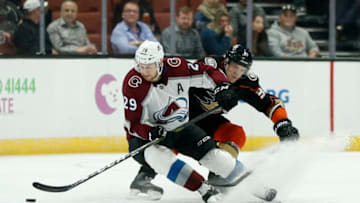 ANAHEIM, CALIFORNIA - MARCH 03: Nathan MacKinnon #29 of the Colorado Avalanche and Jakob Silfverberg #33 of the Anaheim Ducks fight for control of the puck during a game at Honda Center on March 03, 2019 in Anaheim, California. (Photo by Katharine Lotze/Getty Images)