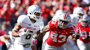 Oct 10, 2015; Columbus, OH, USA; Maryland Terrapins player Ty Johnson (6) runs by Ohio State Buckeyes linebacker Darron Lee (43) during the first half at Ohio Stadium. Ohio State won the game 49-28. Mandatory Credit: Joe Maiorana-USA TODAY Sports