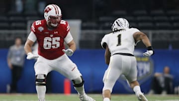 Jan 2, 2017; Arlington, TX, USA; Wisconsin Badgers offensive lineman Ryan Ramczyk (65) blocks Western Michigan Broncos defensive end Keion Adams (1) in the third quarter at AT&T Stadium. The Badgers won 24-16. Mandatory Credit: Tim Heitman-USA TODAY Sports