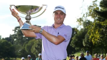ATLANTA, GA - SEPTEMBER 24: Justin Thomas of the United States celebrates with the trophy on the 18th green after winning the FedExCup and second in the TOUR Championship during the final round at East Lake Golf Club on September 24, 2017 in Atlanta, Georgia. (Photo by Sam Greenwood/Getty Images)
