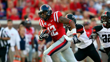 Sep 7, 2013; Oxford, MS, USA; Mississippi Rebels wide receiver Donte Moncrief (12) catches the ball and carries it in for a touchdown during the first half against the Southeast Missouri State Redhawks at Vaught-Hemingway Stadium. Mandatory Credit: Spruce Derden-USA TODAY Sports
