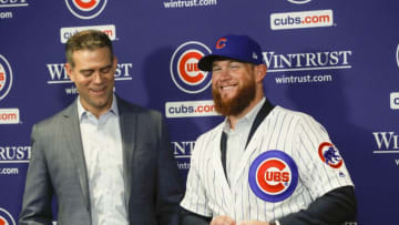 New Chicago Cubs pitcher Craig Kimbrel puts on his new jersey and hat after being introduced by Chicago Cubs President Theo Epstein at Wrigley Field in Chicago on Friday, June 7, 2019. (Jose M. Osorio/Chicago Tribune/TNS via Getty Images)