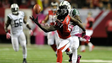 Oct 7, 2013; Atlanta, GA, USA; Atlanta Falcons wide receiver Julio Jones (11) makes a one handed catch behind New York Jets cornerback Antonio Cromartie (31) during the second half at the Georgia Dome. The Jets defeated the Falcons 30-28. Mandatory Credit: Dale Zanine-USA TODAY Sports