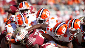 TALLAHASSEE, FL - OCTOBER 27: A group of Clemson Tigers defenders make a tackle for loss against Jacques Patrick #9 of the Florida State Seminoles in the third quarter of the game at Doak Campbell Stadium on October 27, 2018 in Tallahassee, Florida. Clemson won 59-10. (Photo by Joe Robbins/Getty Images)