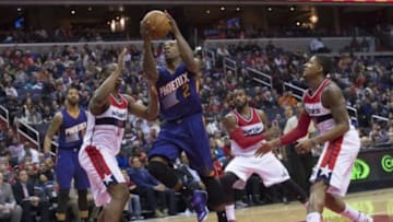 Dec 21, 2014; Washington, DC, USA; Phoenix Suns guard Eric Bledsoe (2) shoot as Washington Wizards center Kevin Seraphin (13) defends during the fourth quarter at Verizon Center. Phoenix Suns defeated Washington Wizards 104-92. Mandatory Credit: Tommy Gilligan-USA TODAY Sports
