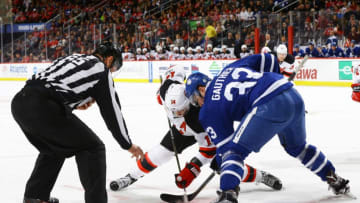 NEW YORK, NY - JANUARY 06: Adam Henrique #14 of the New Jersey Devils takes a face-off against Frederik Gauthier #33 of the Toronto Maple Leafs in the first period at Prudential Center on January 6, 2017 in Newark, New Jersey. (Photo by Andy Marlin/NHLI via Getty Images)