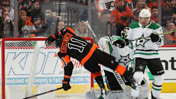 PHILADELPHIA, PA - OCTOBER 19: Travis Konecny #11 of the Philadelphia Flyers is checked to the ice by Andrej Sekera #5 of the Dallas Stars in front of goaltender Ben Bishop #30on October 19, 2019 at the Wells Fargo Center in Philadelphia, Pennsylvania. (Photo by Len Redkoles/NHLI via Getty Images)