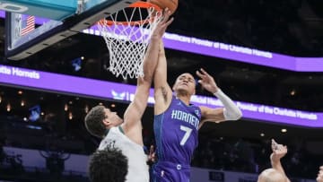 Dec 3, 2022; Charlotte, North Carolina, USA; Charlotte Hornets guard Bryce McGowens (7) tries for a layup blocked by Milwaukee Bucks center Brook Lopez (11) during the first half at the Spectrum Center. Mandatory Credit: Jim Dedmon-USA TODAY Sports