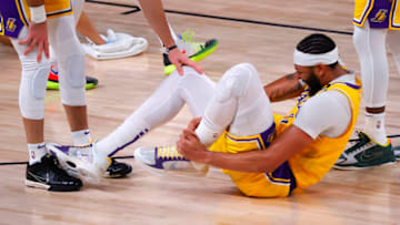 LAKE BUENA VISTA, FLORIDA - SEPTEMBER 24: Anthony Davis #3 of the Los Angeles Lakers goes down holding his ankle after taking a shot during the fourth quarter against the Denver Nuggets in Game Four of the Western Conference Finals during the 2020 NBA Playoffs at AdventHealth Arena at the ESPN Wide World Of Sports Complex on September 24, 2020 in Lake Buena Vista, Florida. NOTE TO USER: User expressly acknowledges and agrees that, by downloading and or using this photograph, User is consenting to the terms and conditions of the Getty Images License Agreement. (Photo by Mike Ehrmann/Getty Images)