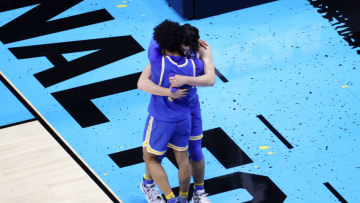INDIANAPOLIS, INDIANA - APRIL 03: Jaime Jaquez Jr. #4 and Johnny Juzang #3 of the UCLA Bruins hug after being defeated by the Gonzaga Bulldogs 93-90 in overtime during the 2021 NCAA Final Four semifinal at Lucas Oil Stadium on April 03, 2021 in Indianapolis, Indiana. (Photo by Andy Lyons/Getty Images)