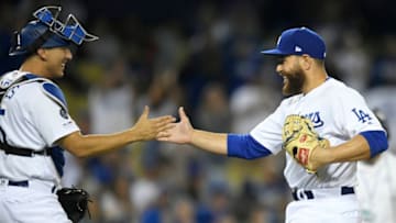 LOS ANGELES, CA - MARCH 30: Catcher Austin Barnes #15 of the Los Angeles Dodgers congratulates pitcher Russell Martin #55 after Martin pitched the ninth inning of a 18-5 victory over the Arizona Diamondbacks at Dodger Stadium on March 30, 2019 in Los Angeles, California. (Photo by John McCoy/Getty Images)