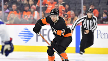 Dec 5, 2021; Philadelphia, Pennsylvania, USA; Philadelphia Flyers left wing Scott Laughton (21) passes the puck against the Tampa Bay Lightning at Wells Fargo Center. Mandatory Credit: Eric Hartline-USA TODAY Sports