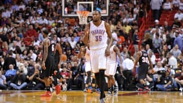Jan 29, 2014; Miami, FL, USA; Oklahoma City Thunder small forward Kevin Durant (35) pumps his fist as Miami Heat small forward LeBron James (6) walks back to the bench during the second half at American Airlines Arena. Mandatory Credit: Steve Mitchell-USA TODAY Sports