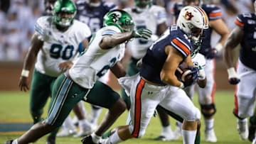 Auburn footballAUBURN, AL - SEPTEMBER 7: Tight end John Samuel Shenker #47 of the Auburn Tigers runs the ball by linebacker Marvin Moody #28 of the Tulane Green Wave during the third quarter at Jordan-Hare Stadium on September 7, 2019 in Auburn, Alabama. (Photo by Michael Chang/Getty Images)