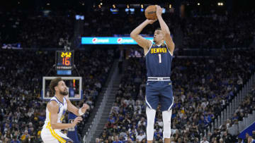 SAN FRANCISCO, CALIFORNIA - OCTOBER 14: Michael Porter Jr. #1 of the Denver Nuggets shoots over Klay Thompson #11 of the Golden State Warriors during the first half of an NBA basketball game at Chase Center on October 14, 2022 in San Francisco, California. NOTE TO USER: User expressly acknowledges and agrees that, by downloading and or using this photograph, User is consenting to the terms and conditions of the Getty Images License Agreement. (Photo by Thearon W. Henderson/Getty Images)