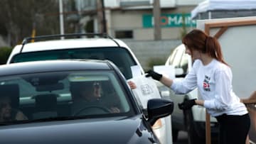 SEATTLE, WA - MARCH 16: An employee delivers food at the new drive through service at the Canlis restaurant on March 16, 2020 in Seattle, Washington. Mark Canlis, co-owner of the Canlis restaurant, opened a drive-thru service to keep all of its staff employed and hopes the experience will encourage people. Governor Jay Inslee ordered all bars, restaurants, entertainment and recreation facilities to temporarily close to fight the spread of coronavirus (COVID-19). (Photo by Karen Ducey/Getty Images)