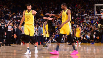 OAKLAND, CA - MARCH 24: Andrew Bogut #12 and Kevin Durant #35 of the Golden State Warriors high-five during a game against the Detroit Pistons on March 24, 2019 at ORACLE Arena in Oakland, California. NOTE TO USER: User expressly acknowledges and agrees that, by downloading and or using this photograph, user is consenting to the terms and conditions of Getty Images License Agreement. Mandatory Copyright Notice: Copyright 2019 NBAE (Photo by Noah Graham/NBAE via Getty Images)