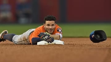 Jun 25, 2016; Kansas City, MO, USA; Houston Astros second basemen Jose Altuve (27) reaches back to touch second base after falling while rounding second base after hitting a double against the Kansas City Royals during the sixth inning at Kauffman Stadium. Mandatory Credit: Peter G. Aiken-USA TODAY Sports