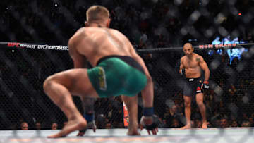 LAS VEGAS, NEVADA - DECEMBER 12: (L-R) Conor McGregor of Ireland crouches in his corner while staring down Jose Aldo of Brazil before their featherweight championship bout during the UFC 194 event inside MGM Grand Garden Arena on December 12, 2015 in Las Vegas, Nevada. (Photo by Jeff Bottari/Zuffa LLC/Zuffa LLC via Getty Images)