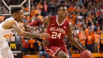 Jan 13, 2016; Stillwater, OK, USA; Oklahoma Sooners guard Buddy Hield (24) dribbles past Oklahoma State Cowboys guard Jeff Newberry (22) during the first half at Gallagher-Iba Arena. OU won 74-72. Mandatory Credit: Rob Ferguson-USA TODAY Sports
