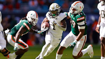 MIAMI GARDENS, FLORIDA - NOVEMBER 06: Jahmyr Gibbs #1 of the Georgia Tech Yellow Jackets runs for a 29-yard touchdown against the Miami Hurricanes during the second quarter at Hard Rock Stadium on November 06, 2021 in Miami Gardens, Florida. (Photo by Michael Reaves/Getty Images)