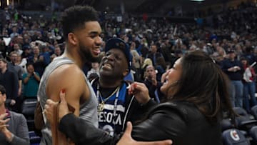 MINNEAPOLIS, MN - APRIL 11: Karl-Anthony Towns #32 of the Minnesota Timberwolves hugs his parents, Karl and Jackie Towns after winning the game against the Denver Nuggets on April 11, 2018 at the Target Center in Minneapolis, Minnesota. The Timberwolves defeated the Nuggets 112-106. NOTE TO USER: User expressly acknowledges and agrees that, by downloading and or using this Photograph, user is consenting to the terms and conditions of the Getty Images License Agreement. (Photo by Hannah Foslien/Getty Images)