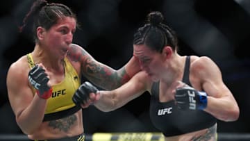 Jun 12, 2021; Glendale, Arizona, USA; Alexis Davis moves in with a hit as Pannie Kianzad defends during UFC 263 at Gila River Arena. Mandatory Credit: Mark J. Rebilas-USA TODAY Sports
