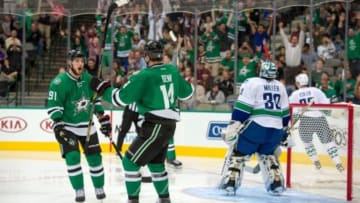 Oct 21, 2014; Dallas, TX, USA; Dallas Stars center Tyler Seguin (91) and left wing Jamie Benn (14) celebrate Benns goal against Vancouver Canucks goalie Ryan Miller (30) during the second period at the American Airlines Center. Mandatory Credit: Jerome Miron-USA TODAY Sports