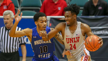 HONOLULU, HI - DECEMBER 23: Joel Ntambwe #24 of the UNLV Runnin' Rebels attempts to drive past Christian Williams #10 of the Indiana State Sycamores during the first half of their game at Stan Sheriff Center on December 23, 2018 in Honolulu, Hawaii. (Photo by Darryl Oumi/Getty Images)