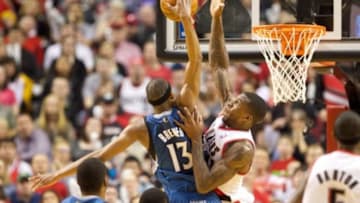 Feb 23, 2014; Portland, OR, USA; Portland Trail Blazers power forward Thomas Robinson (41) blocks the shot by Minnesota Timberwolves small forward Corey Brewer (13) in the second half at Moda Center. Mandatory Credit: Jaime Valdez-USA TODAY Sports