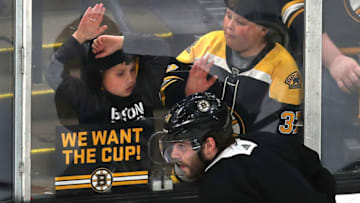 BOSTON, MA - MAY 23: Two fans get a close view of the game and the Boston Bruins' Jake DeBrusk at ice level in the second period of a scrimmage ahead of the start of the 2019 NHL Stanley Cup Finals at TD Garden in Boston on May 23, 2019. (Photo by John Tlumacki/The Boston Globe via Getty Images)