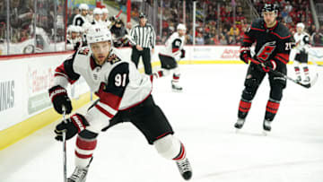 RALEIGH, NC - JANUARY 10: Arizona Coyotes Left Wing Taylor Hall (91) chases a puck into the boards during a game between the Arizona Coyotes and the Carolina Hurricanes on January 10, 2019 at the PNC Arena in Raleigh, NC. (Photo by Greg Thompson/Icon Sportswire via Getty Images)