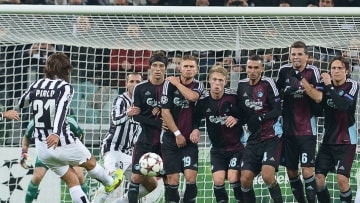 Juventus' midfielder Andrea Pirlo (#21) shoots a free kick in front of FC Copenhagen's defenders during the UEFA Champions League Group B football match Juventus vs Copenhagen, on November 27, 2013 at the Juventus stadium in Turin. AFP PHOTO / GABRIEL BOUYS (Photo credit should read GABRIEL BOUYS/AFP via Getty Images)