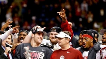 Jan 2, 2014; New Orleans, LA, USA; Oklahoma Sooners quarterback Trevor Knight (9) and head coach Bob Stoops following a win over the Alabama Crimson Tide in a game at the Mercedes-Benz Superdome. Oklahoma defeated Alabama 45-31. Mandatory Credit: Derick E. Hingle-USA TODAY Sports