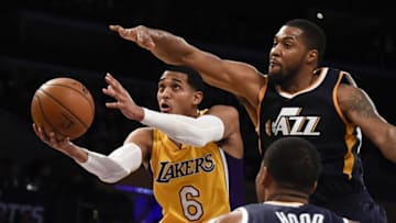 Dec 27, 2016; Los Angeles, CA, USA; Los Angeles Lakers guard Jordan Clarkson (6) shoots the basketball against Utah Jazz forward Derrick Favors (right, top) and guard Rodney Hood (5) during the second quarter at Staples Center. Mandatory Credit: Richard Mackson-USA TODAY Sports