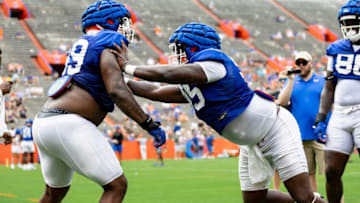 Florida Gators defensive lineman Jamari Lyons (95) participates in a drill against Florida Gators defensive lineman Cam Jackson (99) during fall football practice at Ben Hill Griffin Stadium at the University of Florida in Gainesville, FL on Saturday, August 5, 2023. [Matt Pendleton/Gainesville Sun]