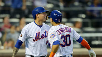NEW YORK, NY - JULY 24: Wilmer Flores #4 and Michael Conforto #30 of the New York Mets celebrate after Conforto drove them both home with home run in the third inning against the San Diego Padres on July 24, 2018 at Citi Field in the Flushing neighborhood of the Queens borough of New York City. (Photo by Elsa/Getty Images)