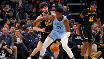 Jan 11, 2022; Memphis, Tennessee, USA; Memphis Grizzles forward Jaren Jackson Jr. (13) dribbles as Golden State Warriors guard Klay Thompson (11) defends during the first half at FedExForum. Mandatory Credit: Petre Thomas-USA TODAY Sports