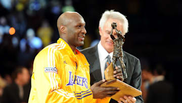 LOS ANGELES, CA - APRIL 20: Lamar Odom #7 of the Los Angeles Lakers receives the Kia Six Man of the Year Award from Lakers General Manager Mitch Kupchak before Game Two of the Western Conference Quarterfinals in the 2011 NBA Playoffs against the New Orleans Hornets on April 20, 2011 at Staples Center in Los Angeles, California. NOTE TO USER: User expressly acknowledges and agrees that, by downloading and or using this photograph, User is consenting to the terms and conditions of the Getty Images License Agreement. (Photo by Harry How/Getty Images)