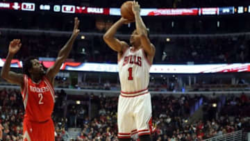 Jan 5, 2015; Chicago, IL, USA; Chicago Bulls guard Derrick Rose (1) makes a jump shot against Houston Rockets guard Patrick Beverley (2) during the game at United Center. The Chicago Bulls beat the Houston Rockets 114-105. Mandatory Credit: Caylor Arnold-USA TODAY Sports