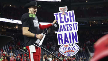 Dec 28, 2022; Houston, Texas, USA; Texas Tech Red Raiders quarterback Tyler Shough (12) reacts after receiving the MVP trophy after the Red Raiders defeated the Mississippi Rebels in the 2022 Texas Bowl at NRG Stadium. Mandatory Credit: Troy Taormina-USA TODAY Sports