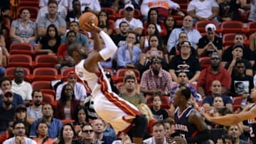 Oct 14, 2014; Miami, FL, USA; Miami Heat guard Dwyane Wade (3) shoots past Atlanta Hawks guard Dennis Schroder (17) during the second half at American Airlines Arena. Mandatory Credit: Steve Mitchell-USA TODAY Sports