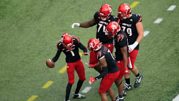 LOUISVILLE, KENTUCKY - OCTOBER 24: Tutu Atwell #1 of the Louisville Cardinals celebrates with teammates after catching a pass for a touchdown against the Florida State Seminoles at Cardinal Stadium on October 24, 2020 in Louisville, Kentucky. (Photo by Andy Lyons/Getty Images)