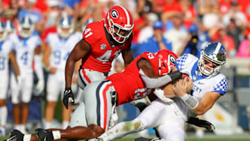 ATHENS, GA - OCTOBER 16: Will Levis #7 of the Kentucky Wildcats rushes for a first down as Adam Anderson #19 of the Georgia Bulldogs makes the tackle in the first half at Sanford Stadium on October 16, 2021 in Athens, Georgia. (Photo by Todd Kirkland/Getty Images)
