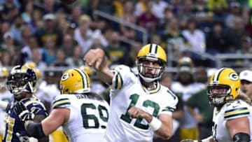 Aug 16, 2014; St. Louis, MO, USA; Green Bay Packers quarterback Aaron Rodgers (12) attempts a pass against the St. Louis Rams during the first half at Edward Jones Dome. Mandatory Credit: Scott Rovak-USA TODAY Sports