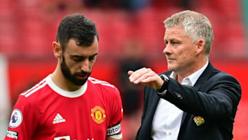 Manchester United's Norwegian manager Ole Gunnar Solskjaer consoles Manchester United's Portuguese midfielder Bruno Fernandes after he missed a penalty during the English Premier League football match between Manchester United and Aston Villa at Old Trafford in Manchester, north west England, on September 25, 2021. - RESTRICTED TO EDITORIAL USE. No use with unauthorized audio, video, data, fixture lists, club/league logos or 'live' services. Online in-match use limited to 120 images. An additional 40 images may be used in extra time. No video emulation. Social media in-match use limited to 120 images. An additional 40 images may be used in extra time. No use in betting publications, games or single club/league/player publications. (Photo by Paul ELLIS / AFP) / RESTRICTED TO EDITORIAL USE. No use with unauthorized audio, video, data, fixture lists, club/league logos or 'live' services. Online in-match use limited to 120 images. An additional 40 images may be used in extra time. No video emulation. Social media in-match use limited to 120 images. An additional 40 images may be used in extra time. No use in betting publications, games or single club/league/player publications. / RESTRICTED TO EDITORIAL USE. No use with unauthorized audio, video, data, fixture lists, club/league logos or 'live' services. Online in-match use limited to 120 images. An additional 40 images may be used in extra time. No video emulation. Social media in-match use limited to 120 images. An additional 40 images may be used in extra time. No use in betting publications, games or single club/league/player publications. (Photo by PAUL ELLIS/AFP via Getty Images)