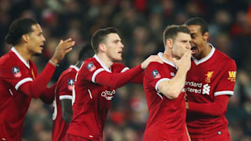 LIVERPOOL, ENGLAND - JANUARY 05: James Milner and Andrew Robertson of Liverpool (2R) celebrates as he scores their first goal from the penalty spot with team mates during the Emirates FA Cup Third Round match between Liverpool and Everton at Anfield on January 5, 2018 in Liverpool, England. (Photo by Clive Brunskill/Getty Images)